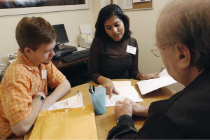 At the Elder Law Clinic in University Station, Law School students Nate Romano and Sejal Gandhi help with a legal issue. 